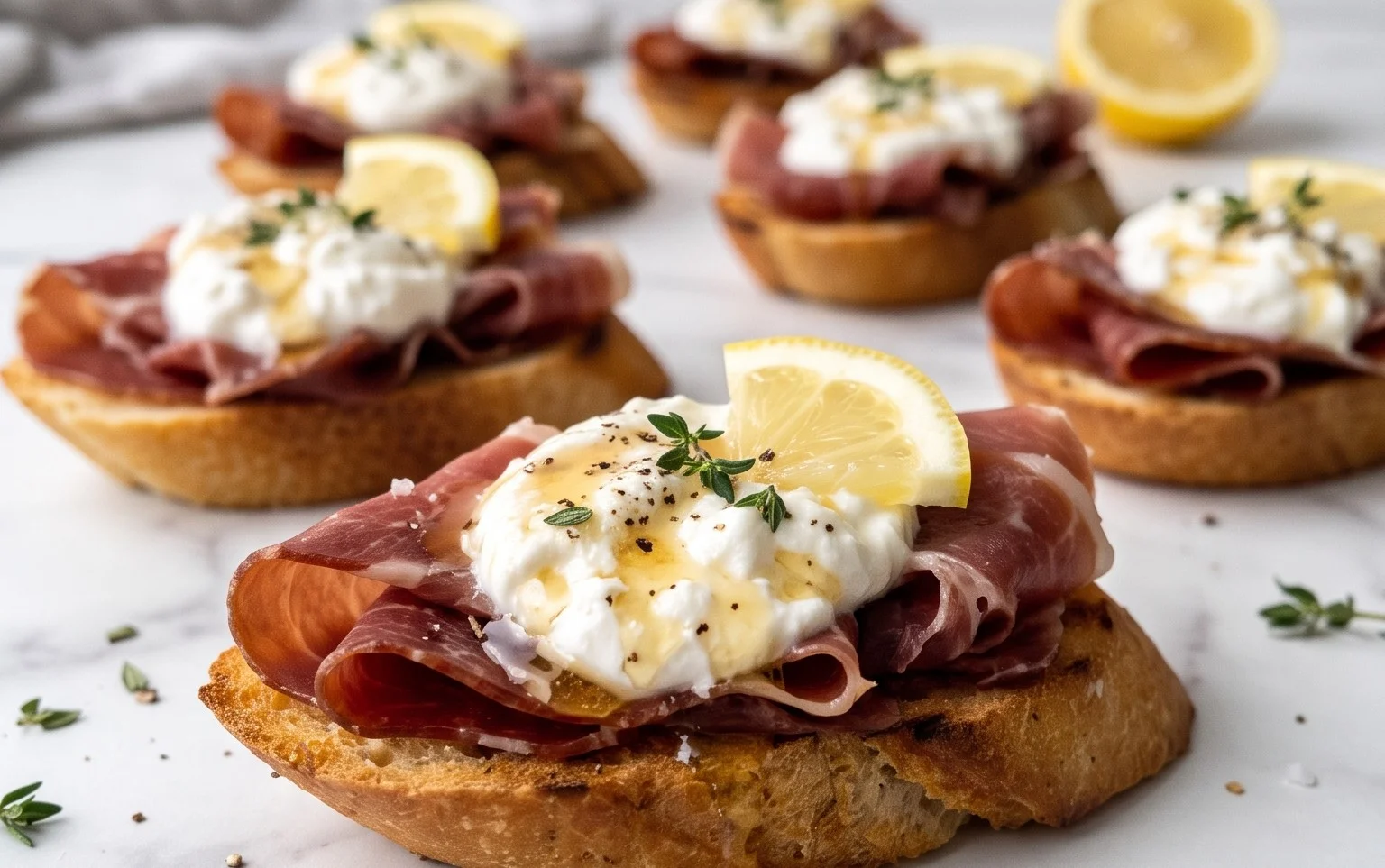 Beef Prosciutto Crostini with Burrata and Lemon Honey Drizzle